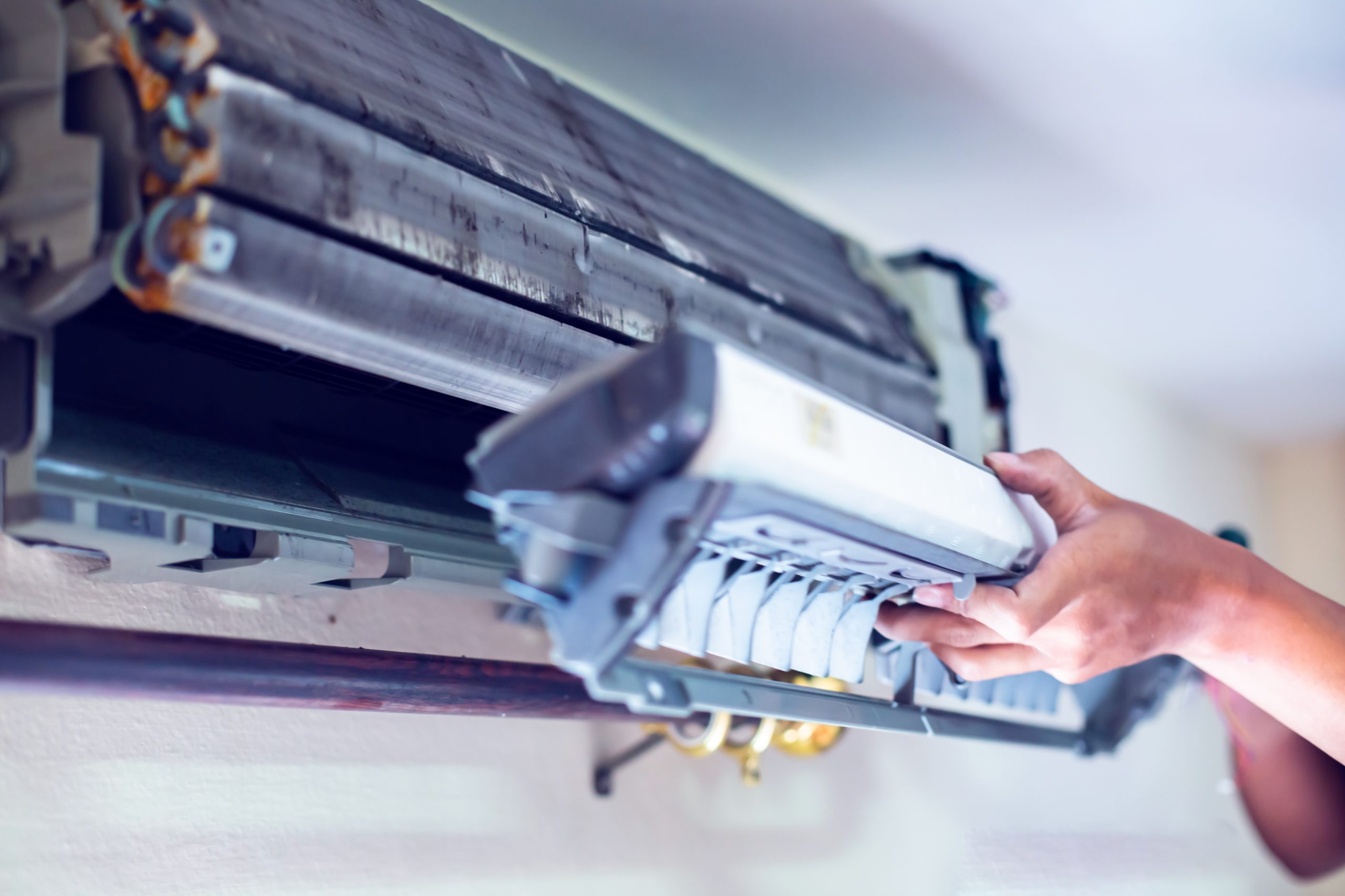 Selective focus to hand of male technician to cleaning air condi